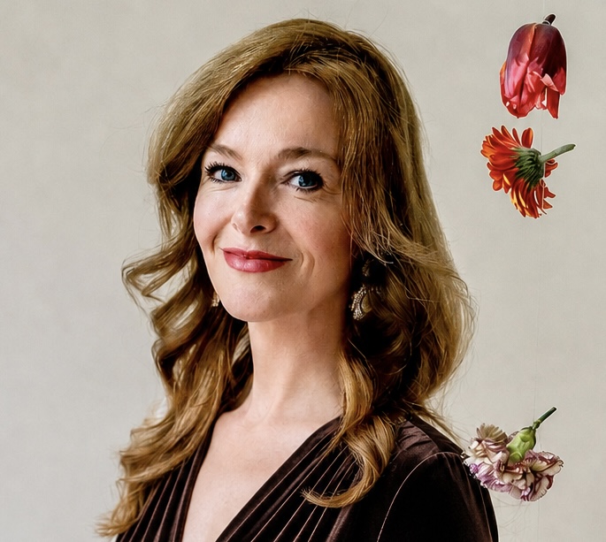 A woman in a dark brown velvet dress, warm and composed